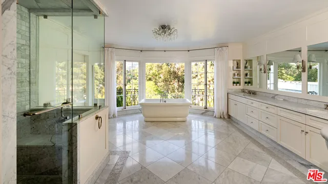a large living room with a large tub and shower