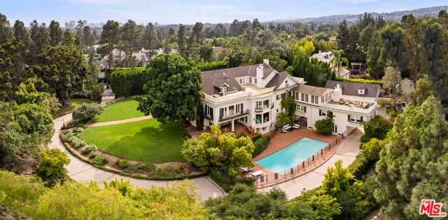 an aerial view of a house with a garden and trees