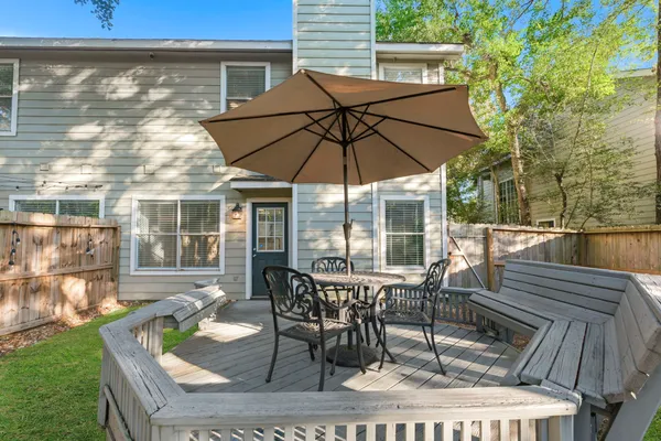 a view of a patio with table and chairs under an umbrella