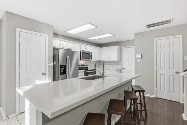 a kitchen with a sink and cabinets