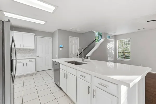 a kitchen with kitchen island a sink stove and refrigerator