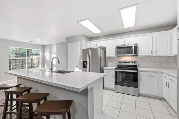 a kitchen with a sink and a stove top oven