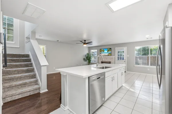 a kitchen with stainless steel appliances a stove microwave and cabinets