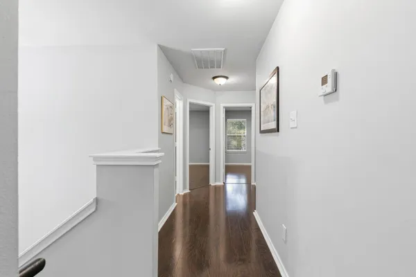 a bedroom with a bed and painting on the wall