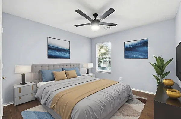 an empty room with wooden floor windows and ceiling fan