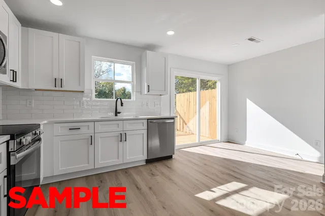 a kitchen with cabinets stainless steel appliances and a sink
