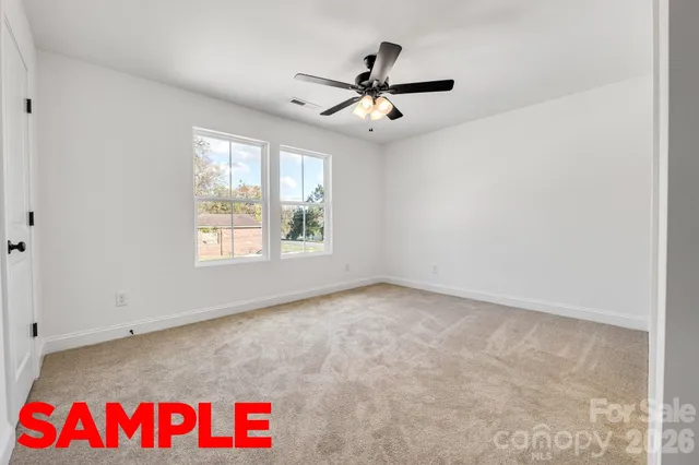 an empty room with cabinet and a ceiling fan