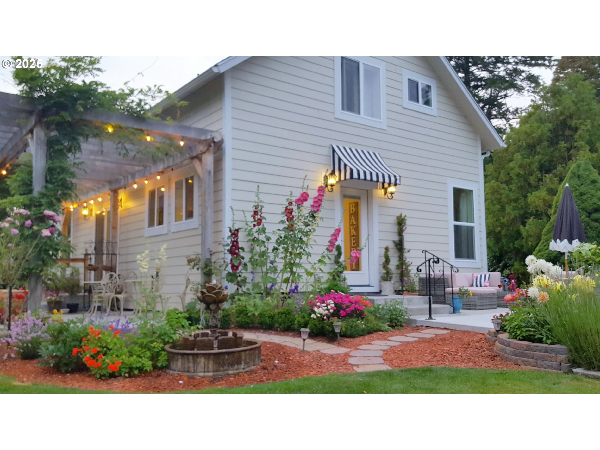 a backyard of a house with a table and chairs