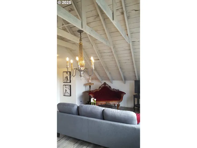 a living room with furniture and a white wall