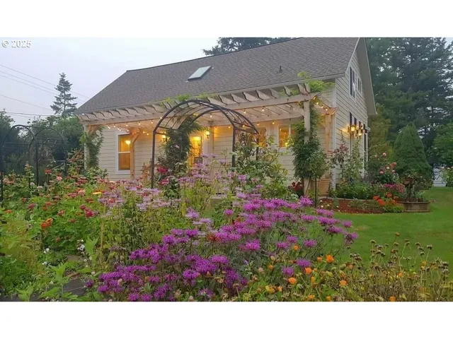 a view of a house with a big yard and potted plants
