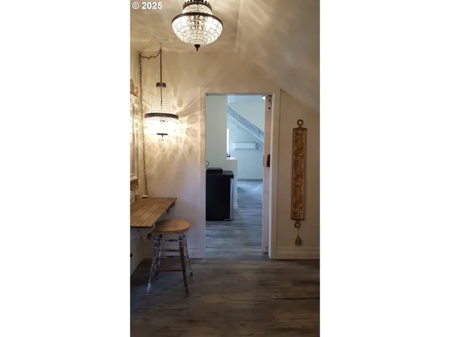 a hallway with a table and a mirror
