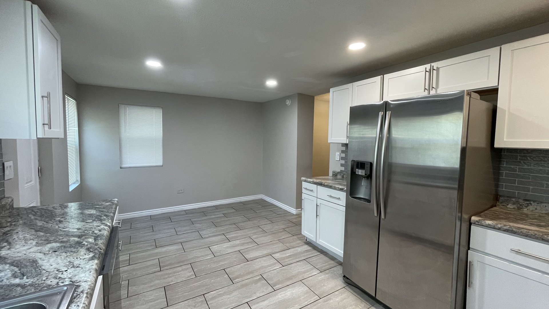 6511 South Vernon Avenue Chicago, IL 60637 - Photo 11 of 12 a modern kitchen with stainless steel appliances granite countertop a refrigerator and a sink