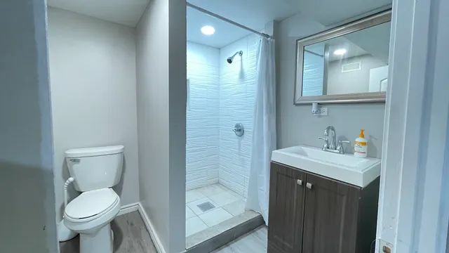 a bathroom with a sink toilet and shower