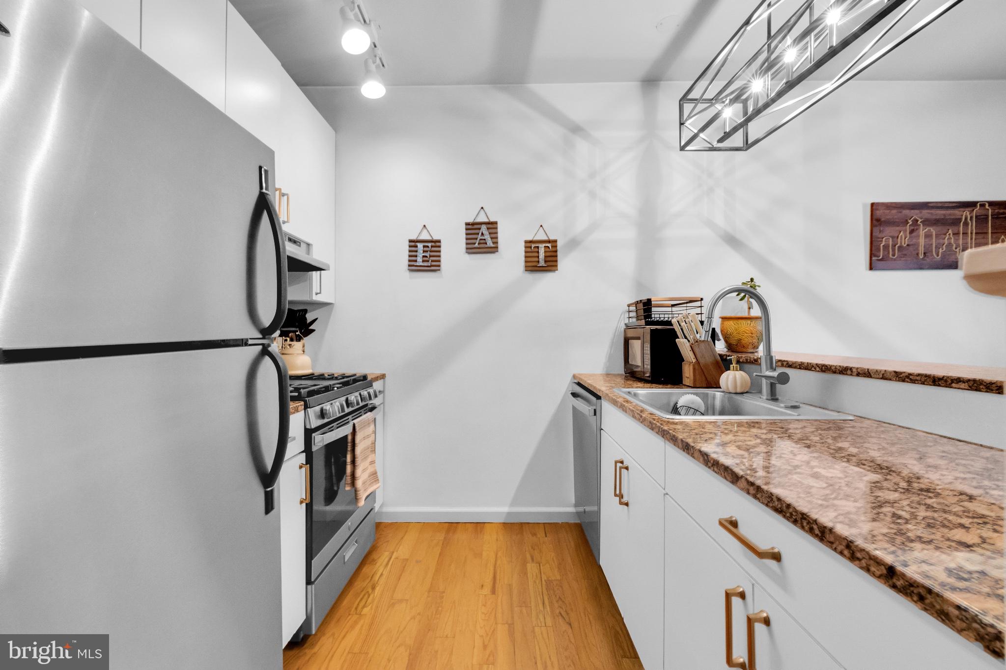 182 Gay Street, Unit 104 Philadelphia, PA 19128 - Photo 13 of 23 a hallway with sink and mirror washer