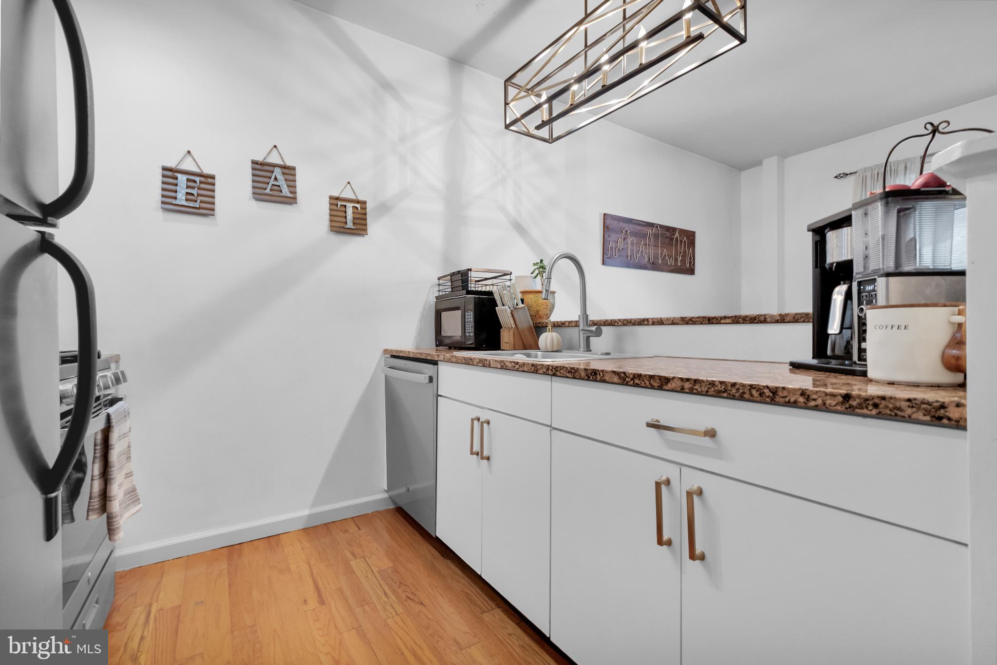 182 Gay Street, Unit 104 Philadelphia, PA 19128 - Photo 15 of 23 a kitchen with sink cabinets and appliances