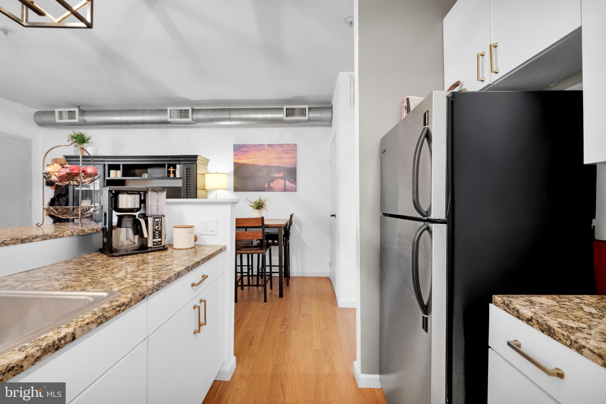 182 Gay Street, Unit 104 Philadelphia, PA 19128 - Photo 16 of 23 a kitchen with stainless steel appliances granite countertop a refrigerator and a sink