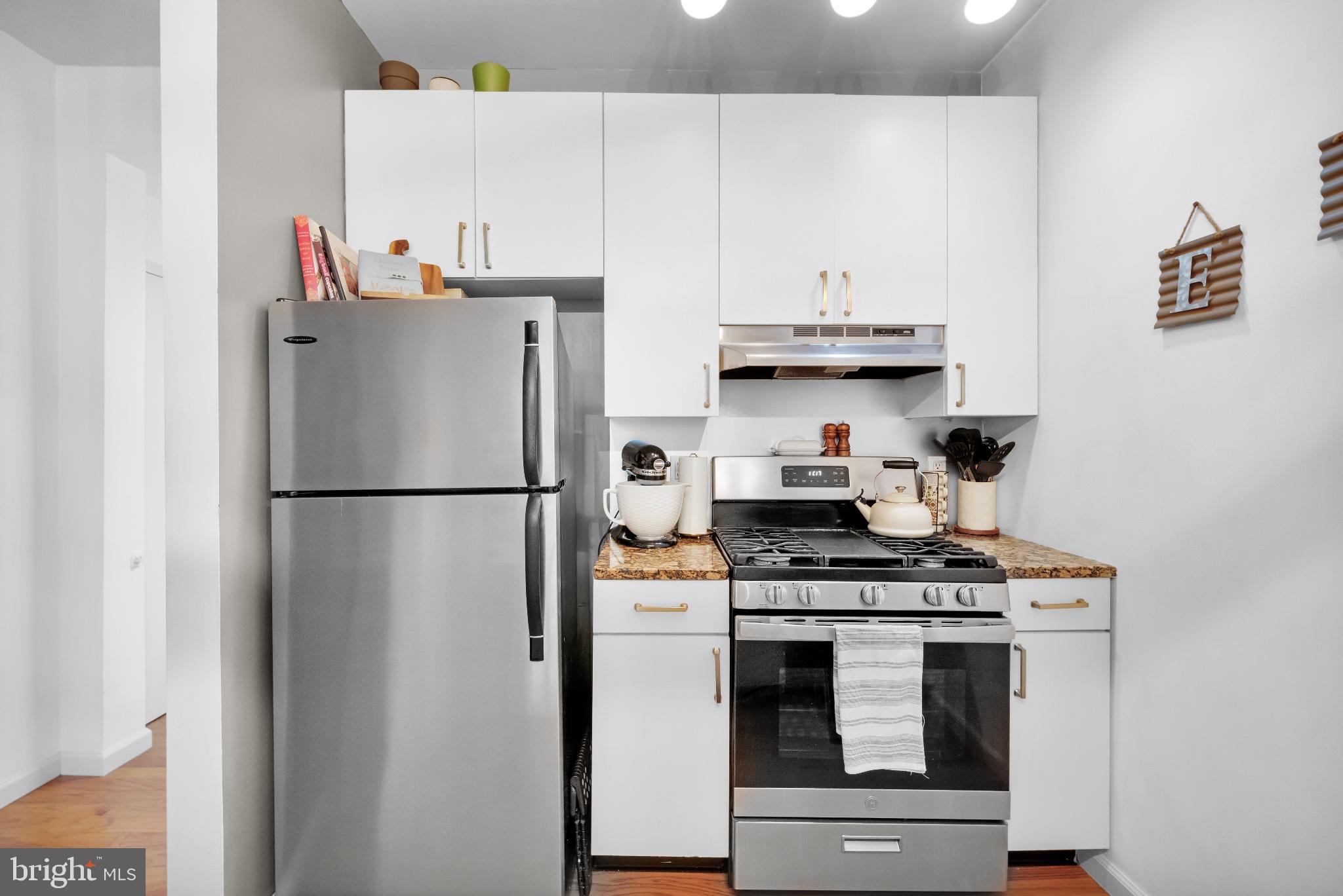 182 Gay Street, Unit 104 Philadelphia, PA 19128 - Photo 18 of 23 a kitchen with stainless steel appliances granite countertop a refrigerator sink and stove