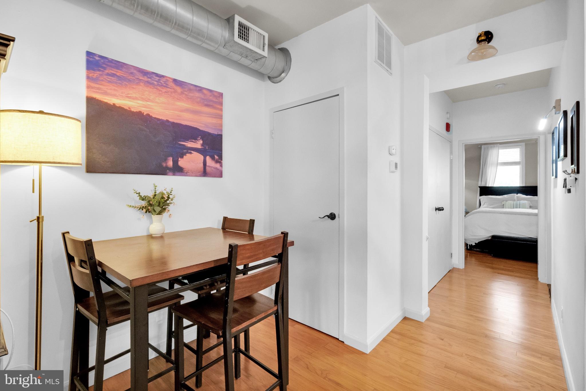 182 Gay Street, Unit 104 Philadelphia, PA 19128 - Photo 20 of 23 a view of a dining room with furniture and wooden floor