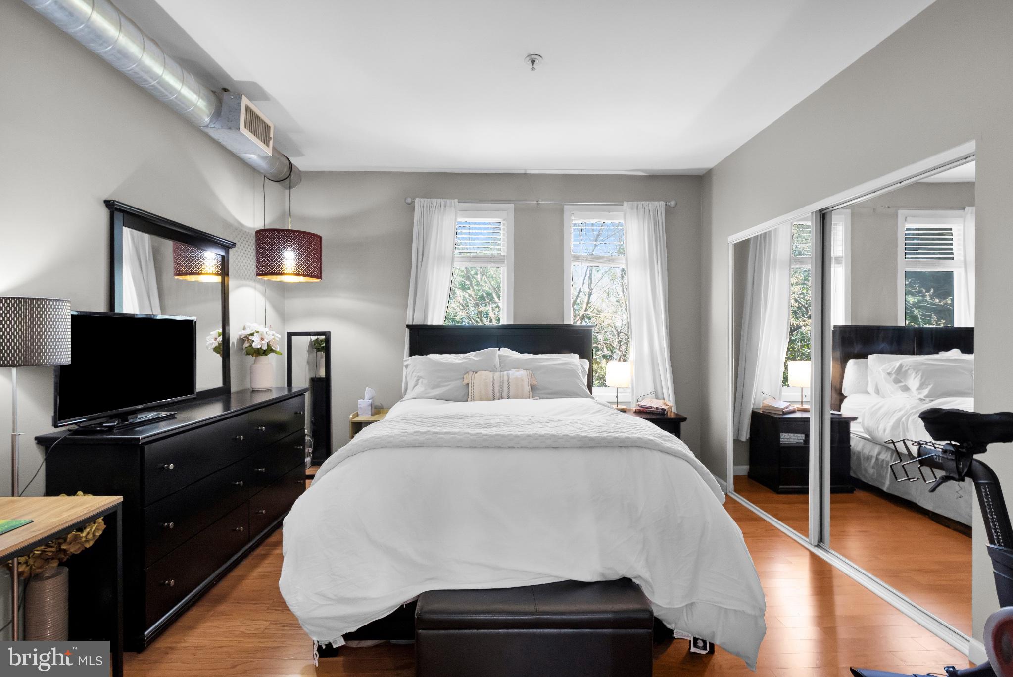 182 Gay Street, Unit 104 Philadelphia, PA 19128 - Photo 4 of 23 a bed room with a bed and a television