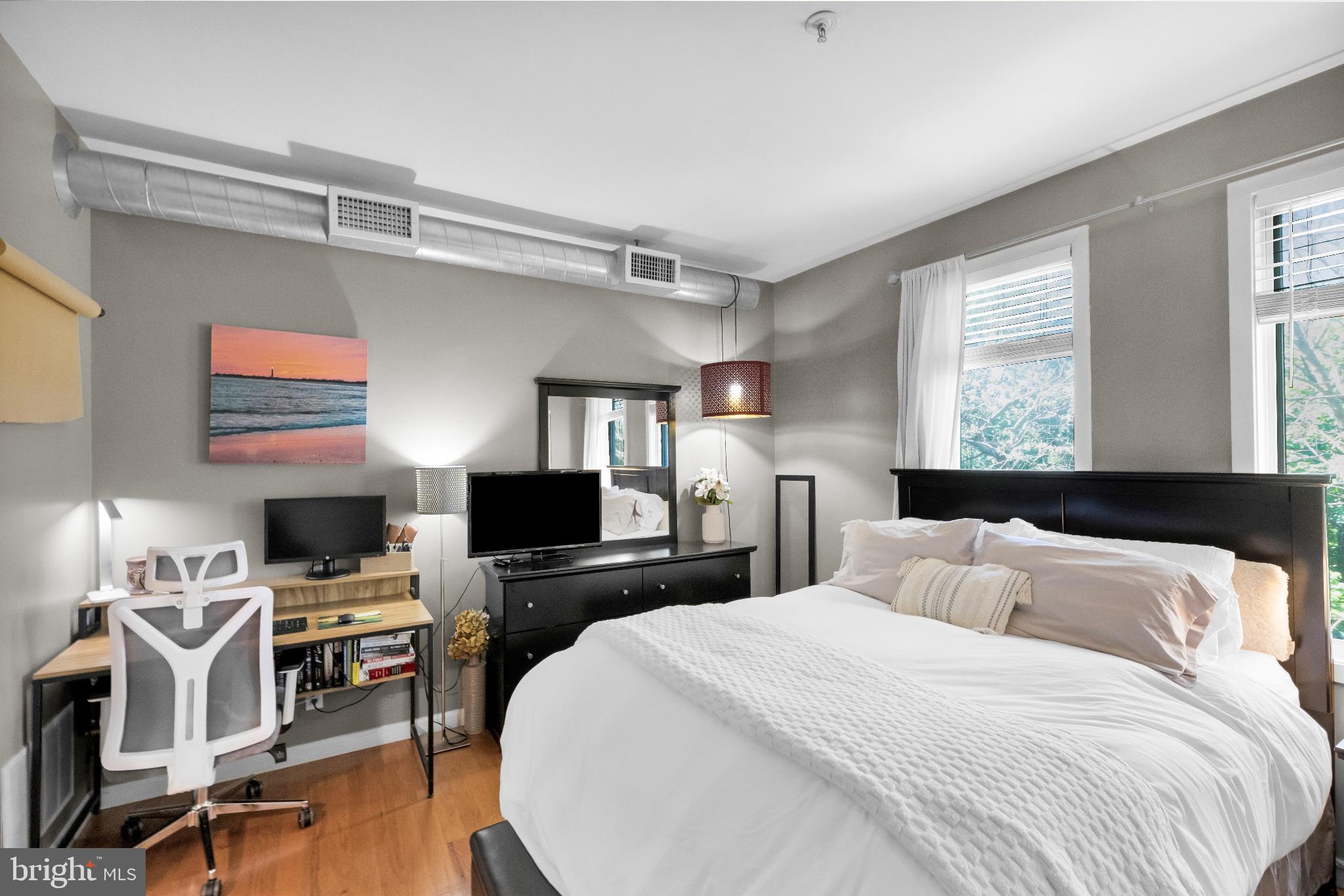 182 Gay Street, Unit 104 Philadelphia, PA 19128 - Photo 5 of 23 a bedroom with a bed and a flat screen tv