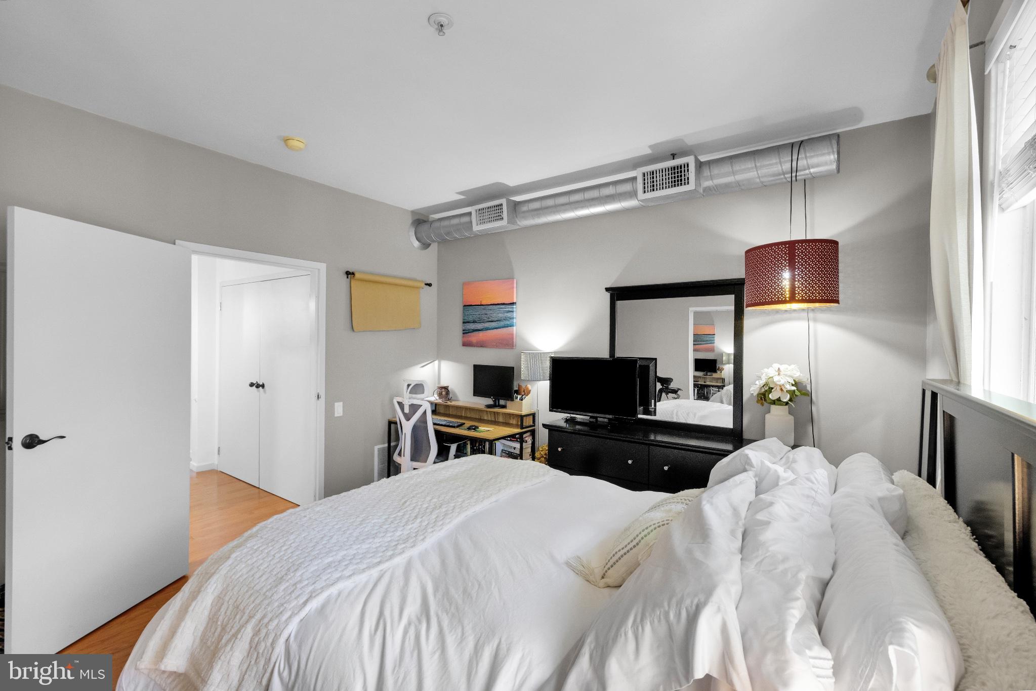 182 Gay Street, Unit 104 Philadelphia, PA 19128 - Photo 6 of 23 a bedroom with a bed and a flat screen tv