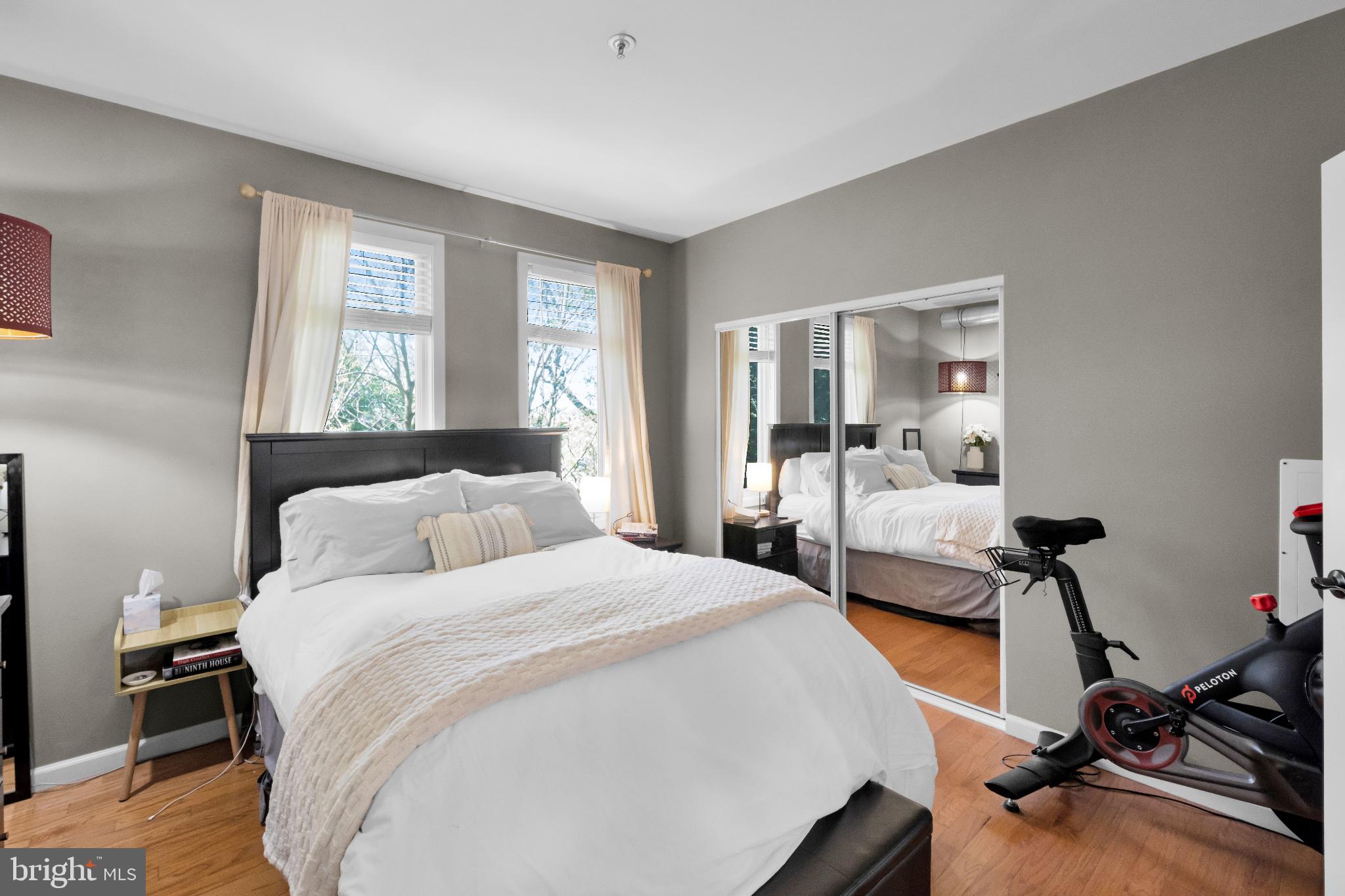 182 Gay Street, Unit 104 Philadelphia, PA 19128 - Photo 7 of 23 a bedroom with a bed and wooden floor