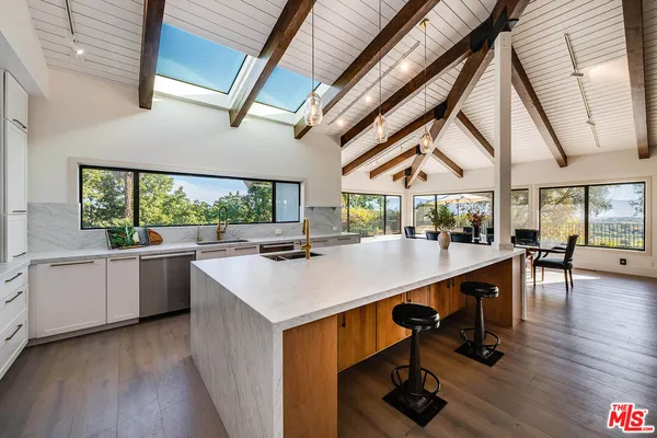 a living room with furniture and large windows