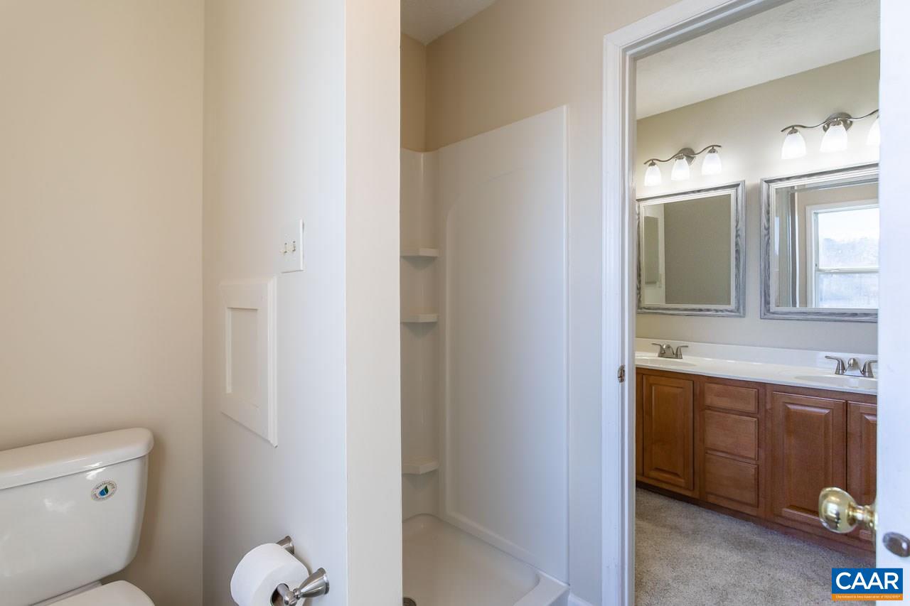 524 West Daffodil Road Ruckersville, VA 22968 - Photo 18 of 29 a spacious bathroom with a granite countertop toilet and a sink
