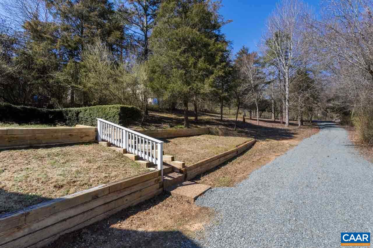 524 West Daffodil Road Ruckersville, VA 22968 - Photo 3 of 29 a view of a backyard with a patio and wooden fence