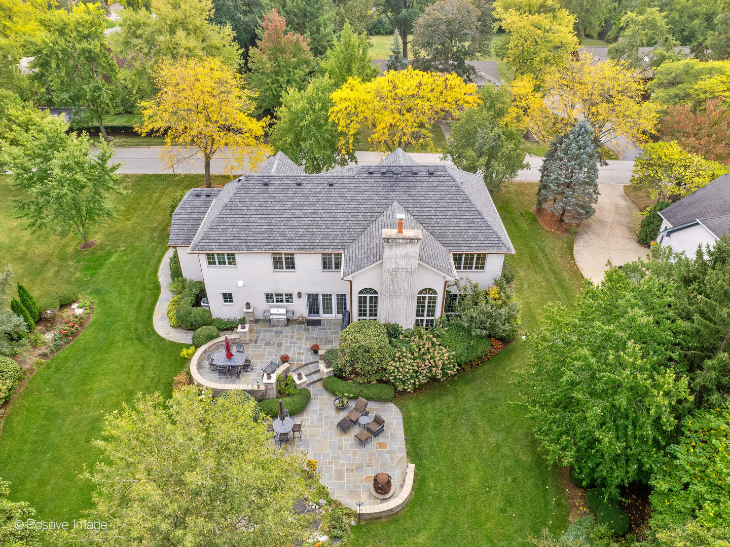 15-w601 81st Street Burr Ridge, IL 60527 - Photo 2 of 42 a aerial view of a house with table and chairs under an umbrella