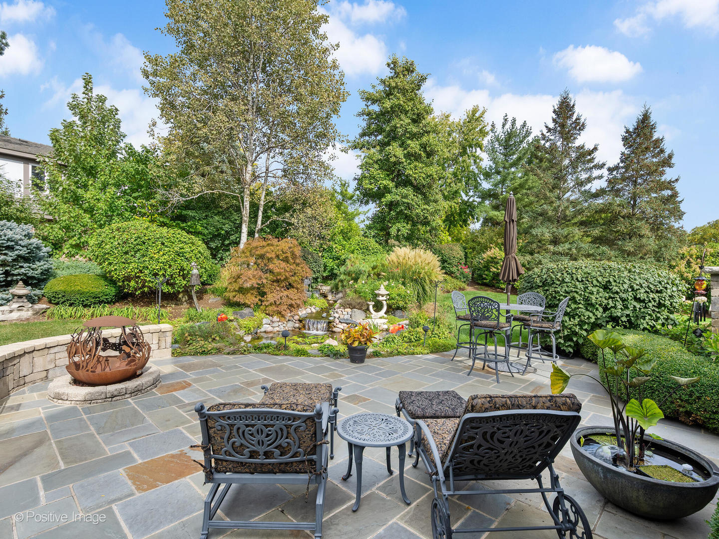 15-w601 81st Street Burr Ridge, IL 60527 - Photo 32 of 42 a backyard with table and chairs potted plants and fire pit