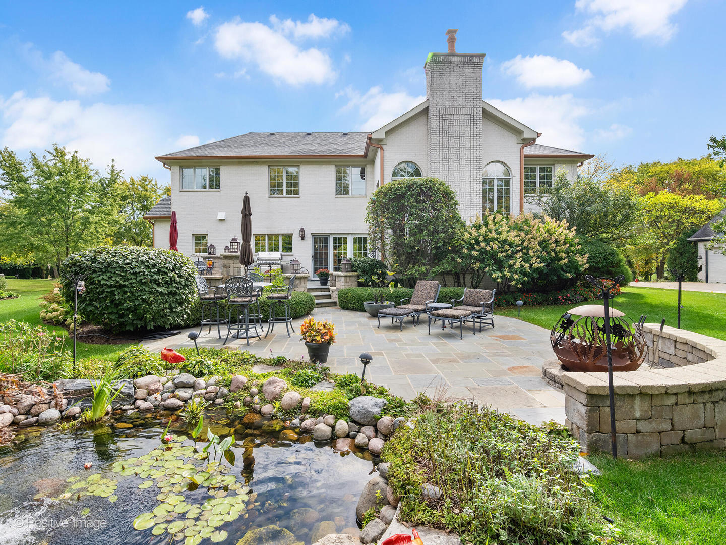 15-w601 81st Street Burr Ridge, IL 60527 - Photo 33 of 42 a view of a white house with a yard and potted plants