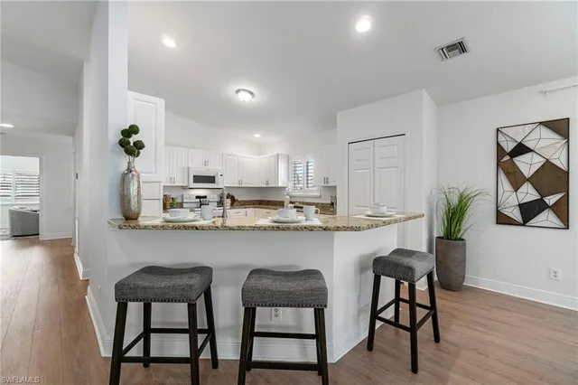 a dining room with furniture and a chandelier