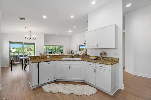 a kitchen with granite countertop a sink stove and refrigerator