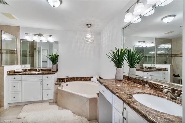 a bathroom with a granite countertop sink a mirror and a shower