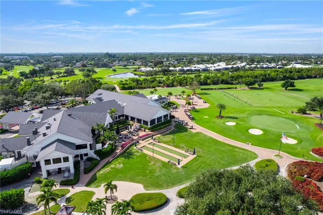 an aerial view of residential houses with outdoor space and ocean view