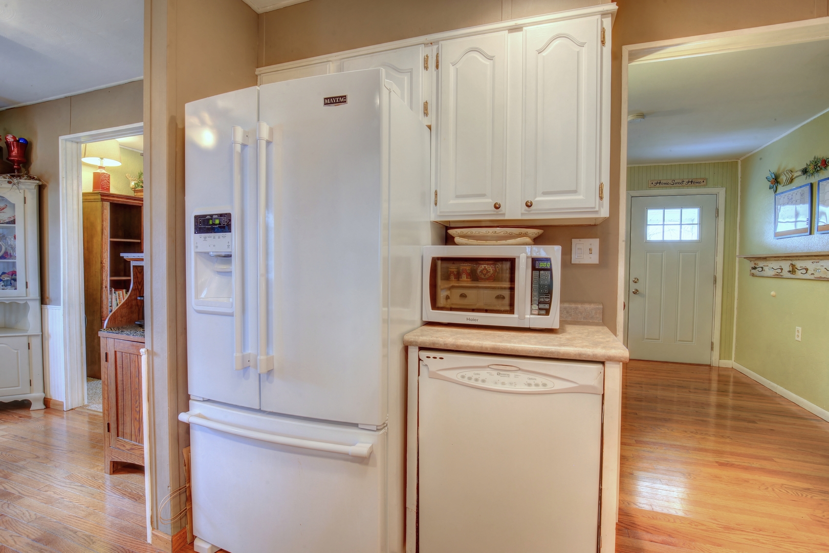 335 Dodge Street Cisco, IL 61830 - Photo 6 of 16 a kitchen with cabinets and a refrigerator