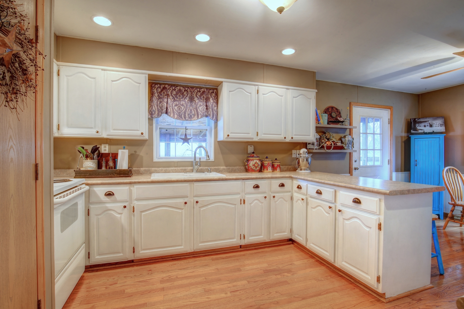 335 Dodge Street Cisco, IL 61830 - Photo 7 of 16 a kitchen with granite countertop white cabinets and white stainless steel appliances