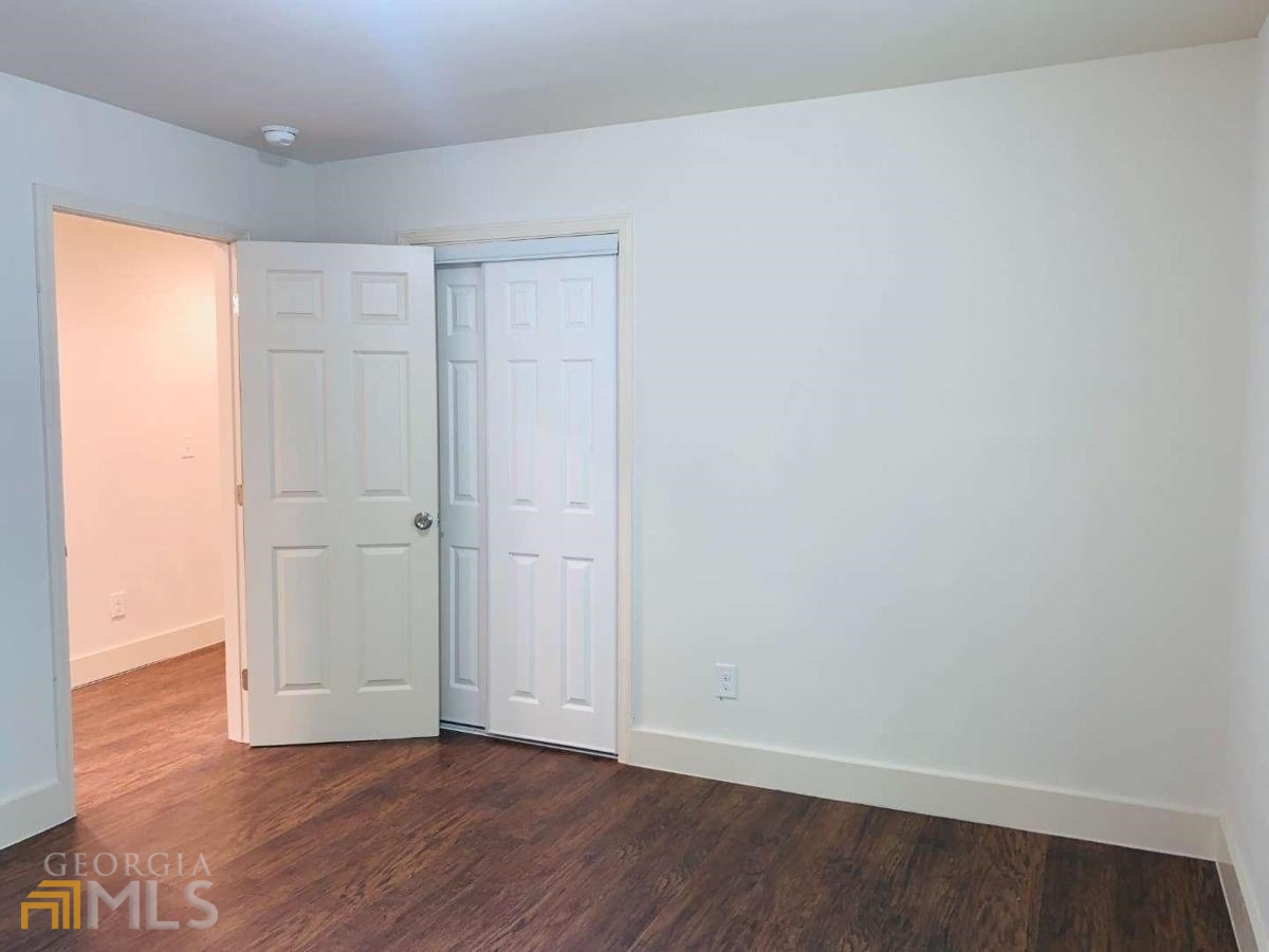 364 Brooks Avenue Southwest Atlanta, GA 30310 - Photo 14 of 21 an empty room with wooden floor