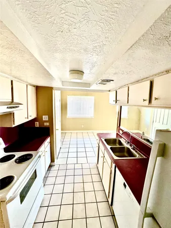 a kitchen with a sink and a stove top oven