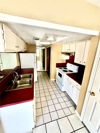 a kitchen with stainless steel appliances a sink and a stove