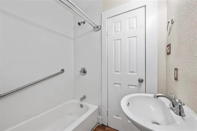 a white bath tub sitting next to a white sink