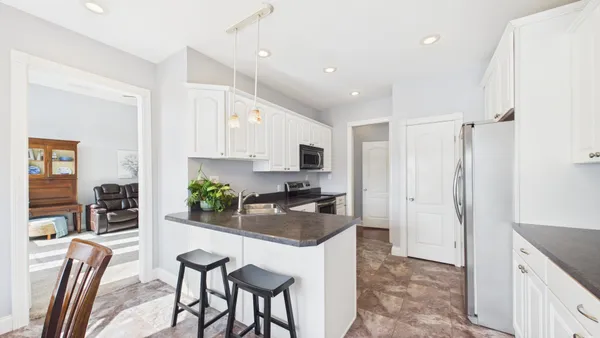 a kitchen with a sink stove top oven and cabinets