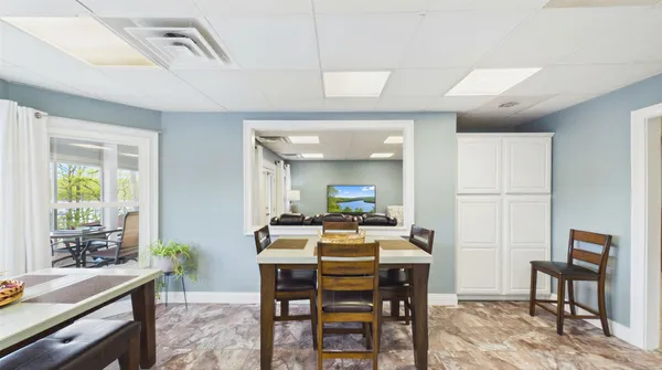 a view of a swimming pool with a patio and fire pit