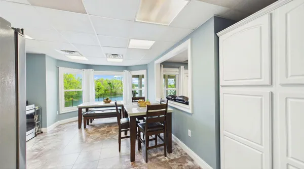 a view of a patio with a table chairs and a potted plant