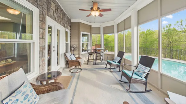 a view of swimming pool with a table and chairs in patio
