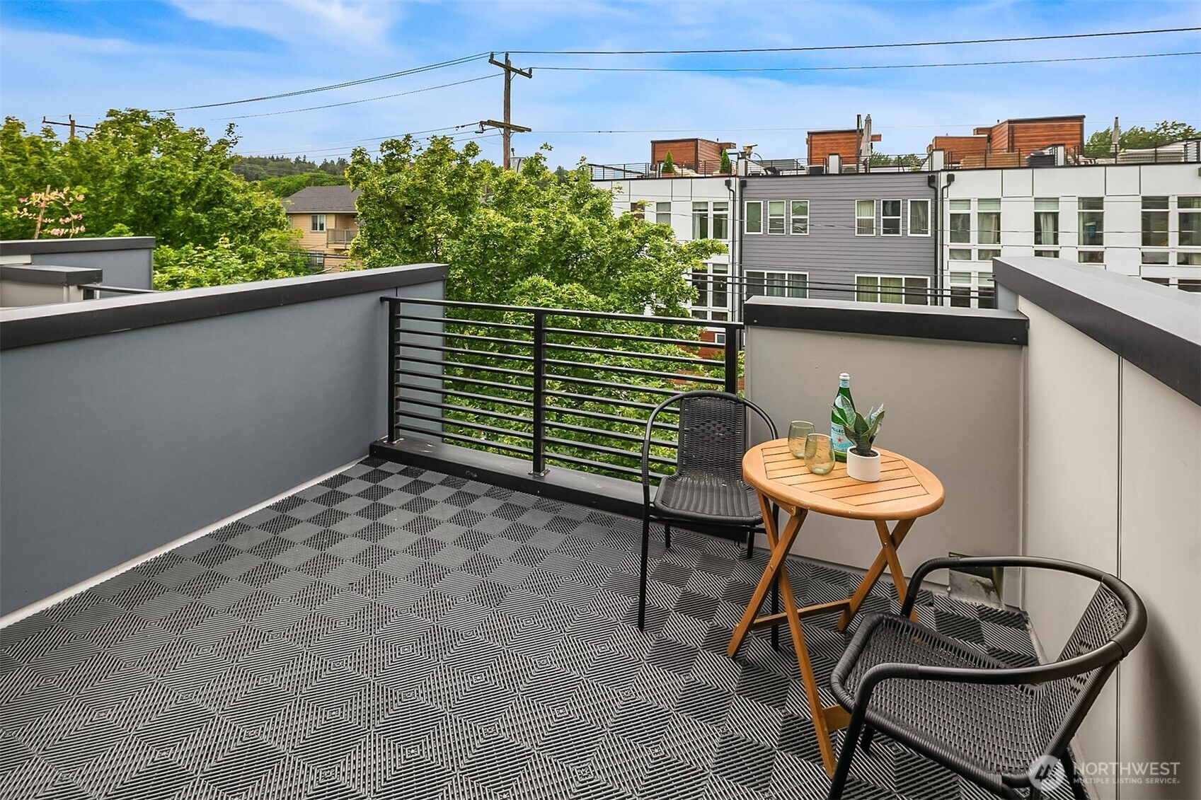 4308 26th Avenue Southwest, Unit F Seattle, WA 98106 - Photo 16 of 21 a balcony with table and chairs