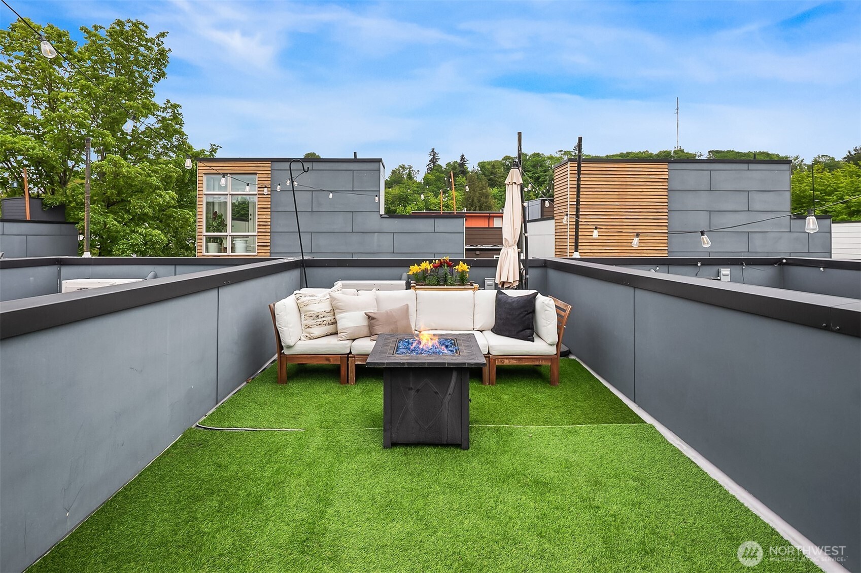 4308 26th Avenue Southwest, Unit F Seattle, WA 98106 - Photo 2 of 21 a view of a patio with lawn chairs and a yard