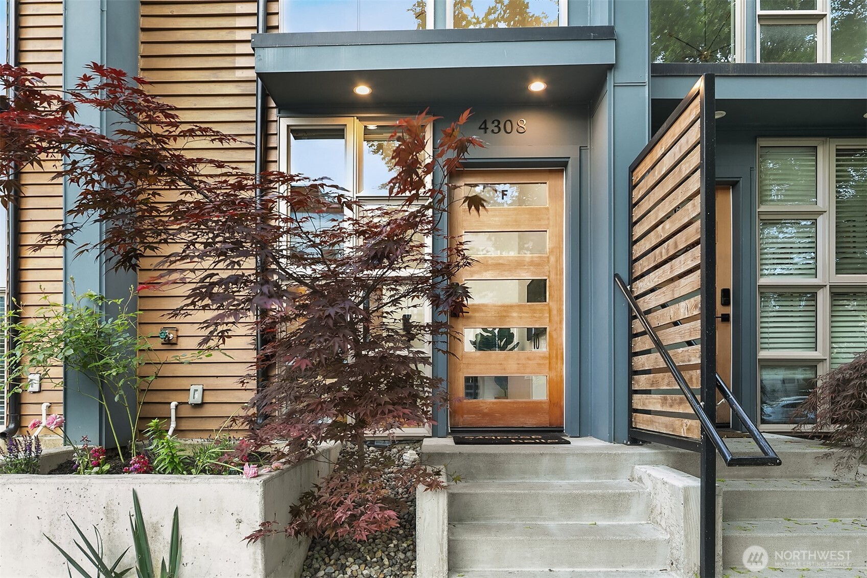 4308 26th Avenue Southwest, Unit F Seattle, WA 98106 - Photo 3 of 21 a front view of a house with a yard