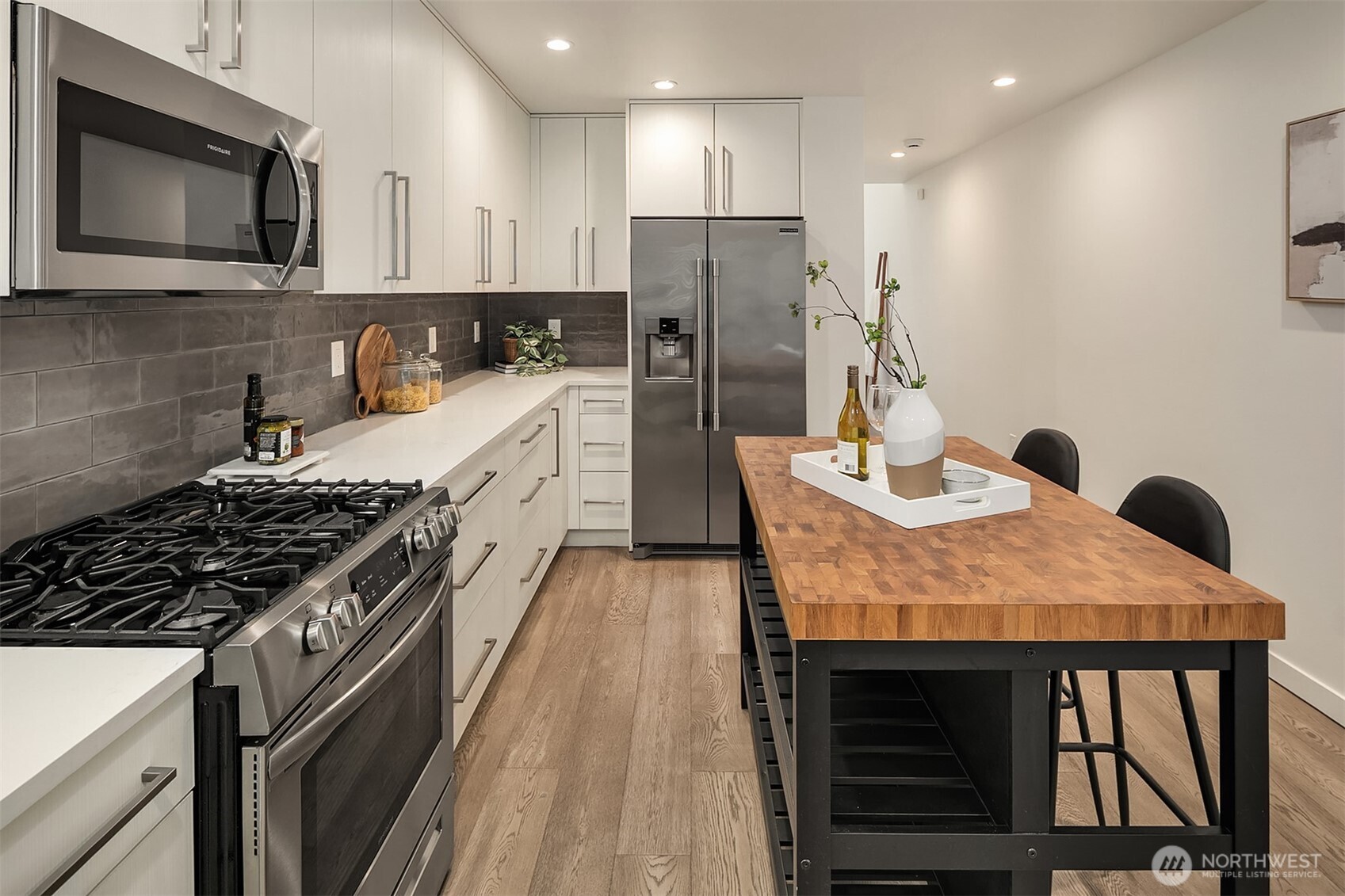 4308 26th Avenue Southwest, Unit F Seattle, WA 98106 - Photo 9 of 21 a kitchen with stainless steel appliances granite countertop a stove refrigerator and microwave